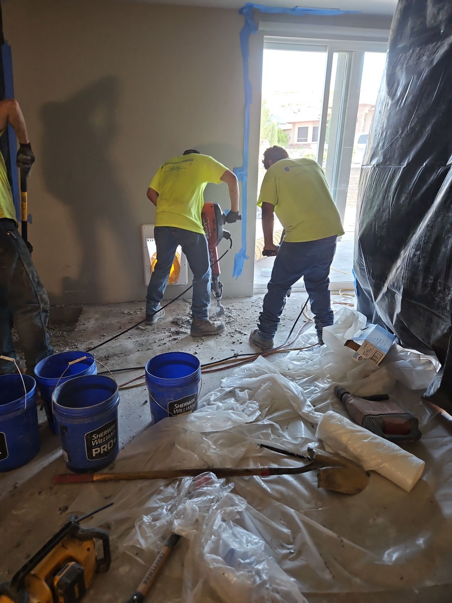 Crew installing black liner barriers around openings as part of encapsulation